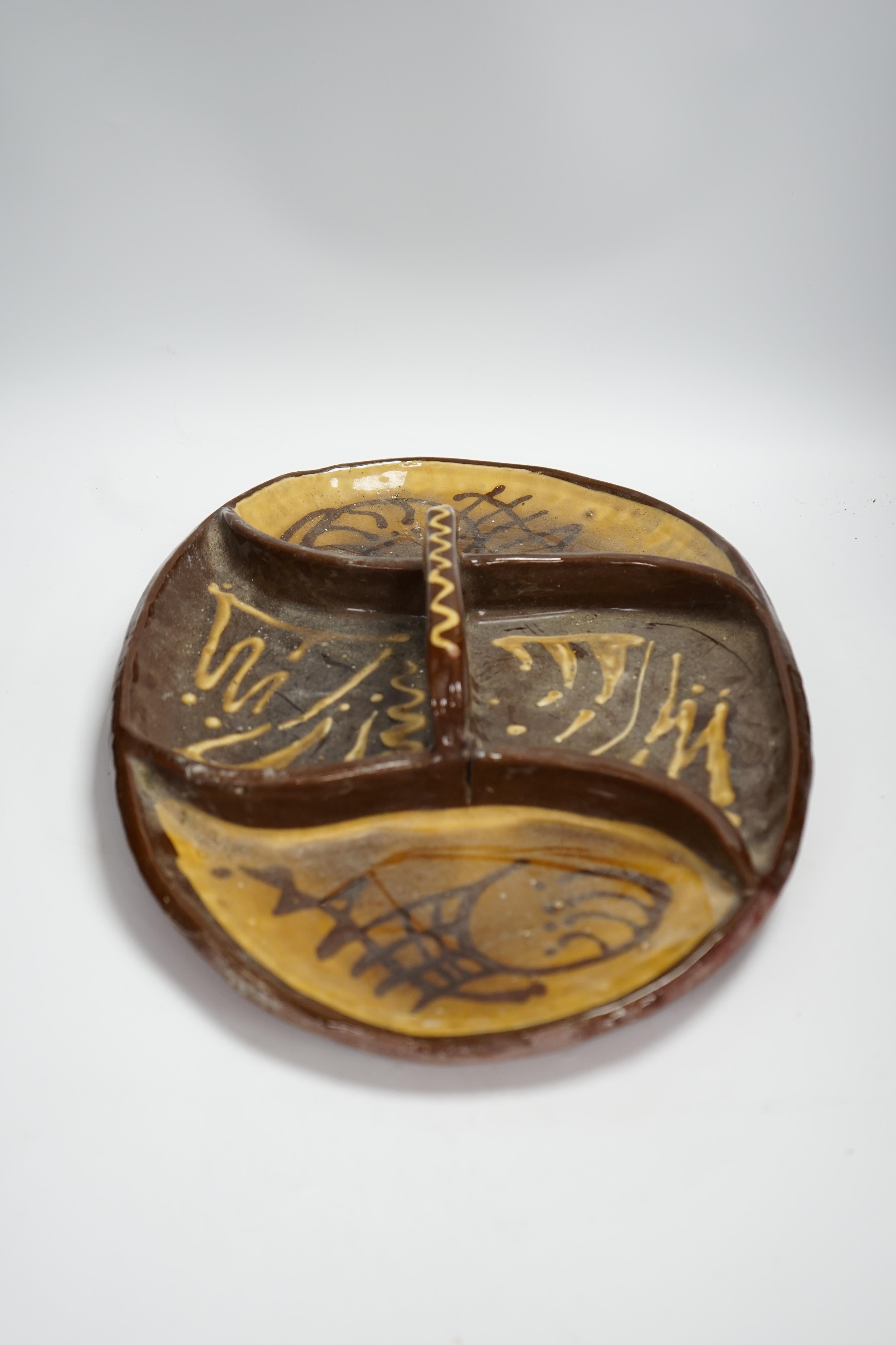 A set of nine studio pottery plates together with a slipware dish, 46cm long